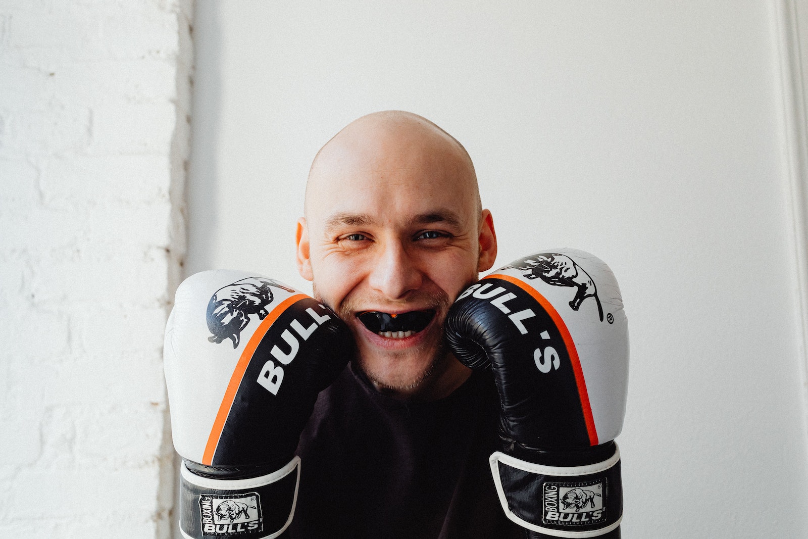 Smiling Man Wearing Mouth Guard and Boxing Gloves