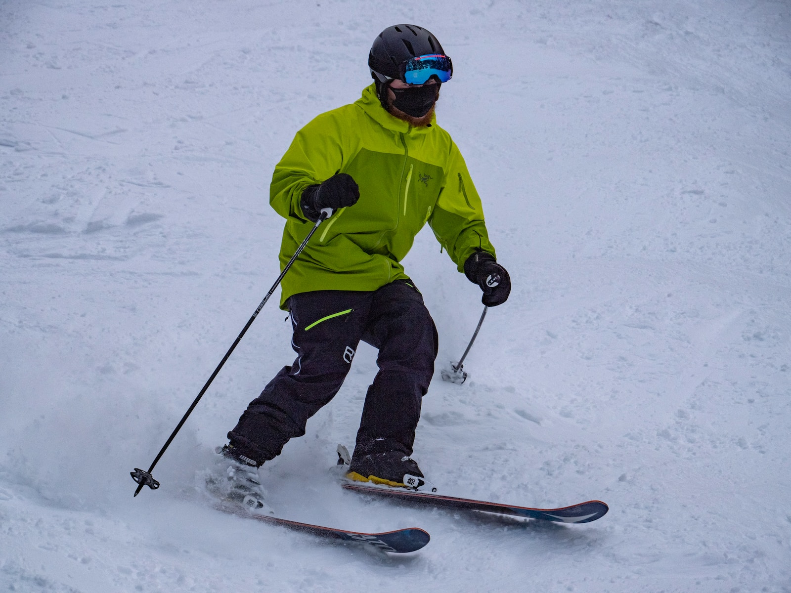person in green jacket and black pants riding on snowboard