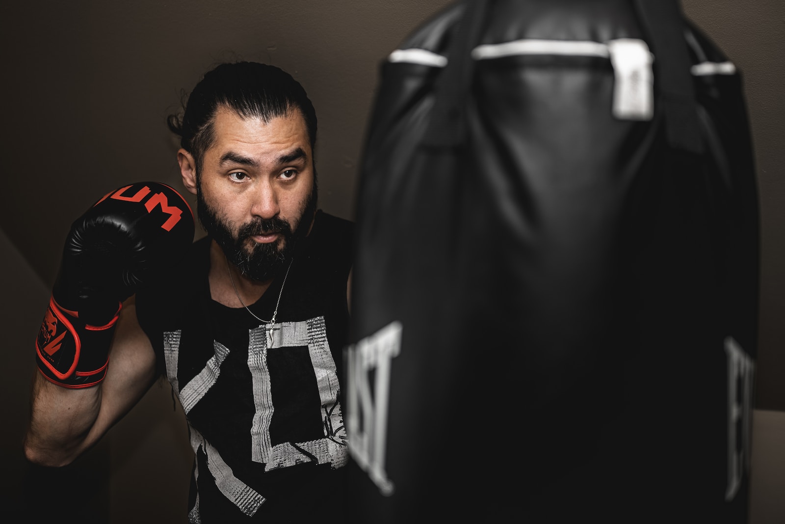 a man with a beard wearing boxing gloves